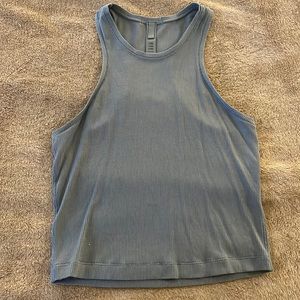 Skims light blue tank.